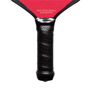 Close-up of a black pickleball paddle grip with perforated texture and USA PICKLEBALL APPROVED text.