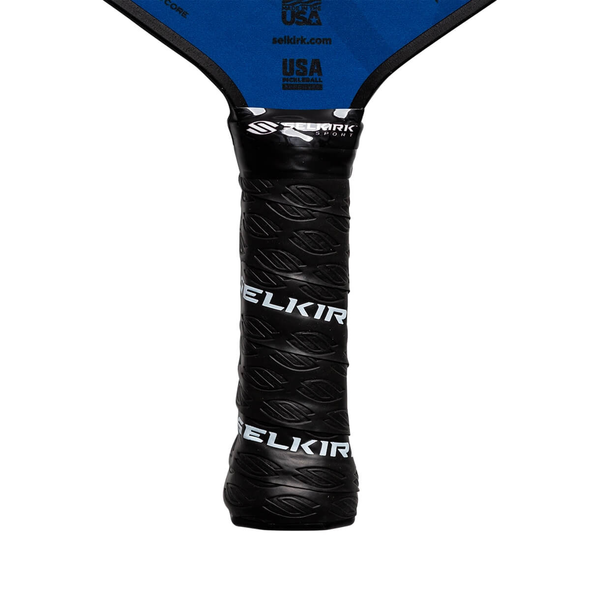 Close-up of a black pickleball paddle grip with embossed SELKIRK text and a textured pattern.