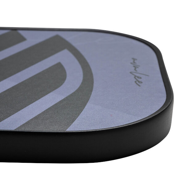 Corner view of a purple pickleball paddle with a black border and gray graphic design.