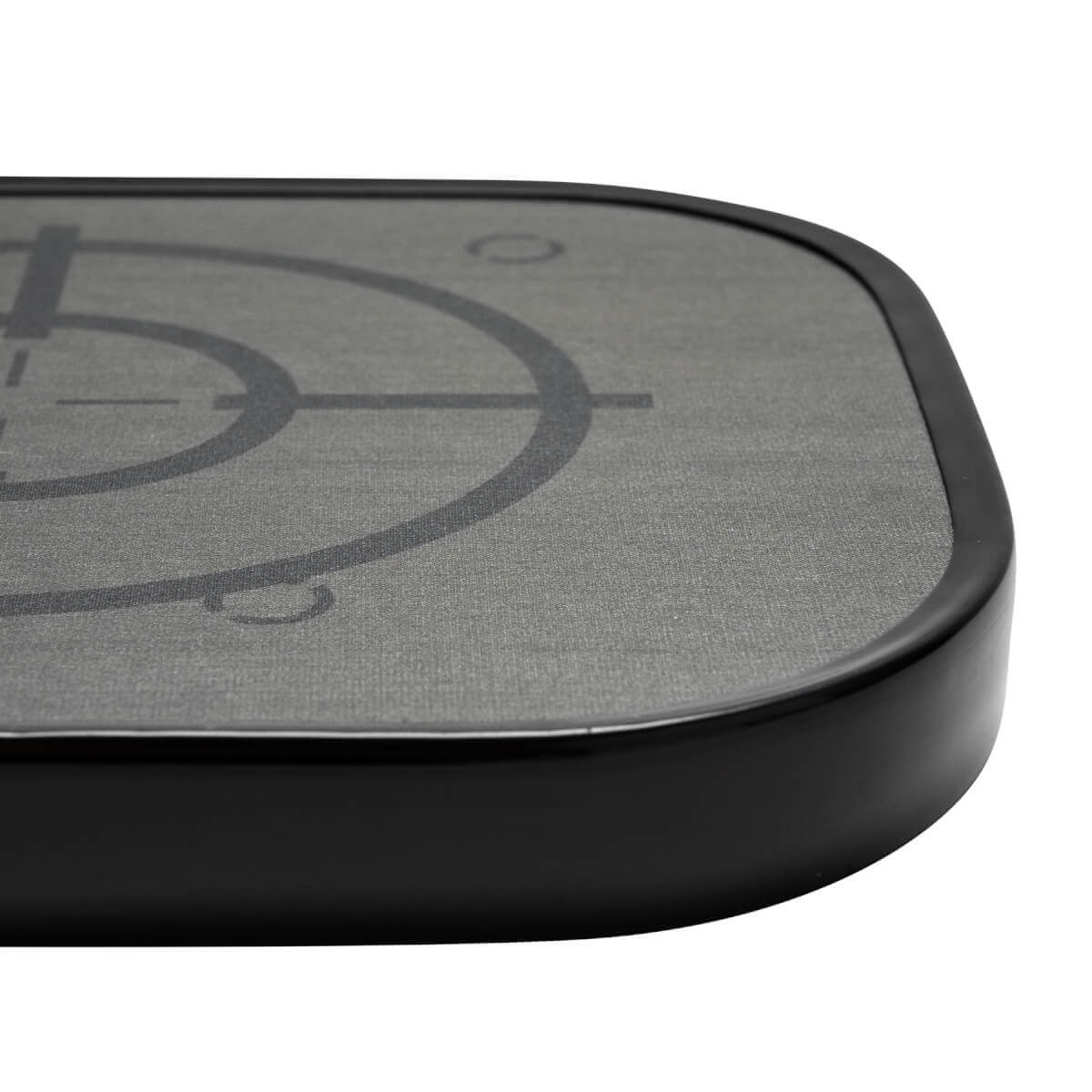 Corner view of a gray pickleball paddle with a black edge and target graphic.