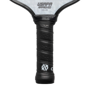 Close-up of a black pickleball paddle grip with perforated texture and white logo.