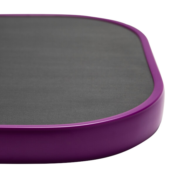 Corner view of a purple pickleball paddle with a dark gray textured surface.