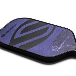 Corner view of a purple pickleball paddle with Selkirk branding and Invikta AMPED text.