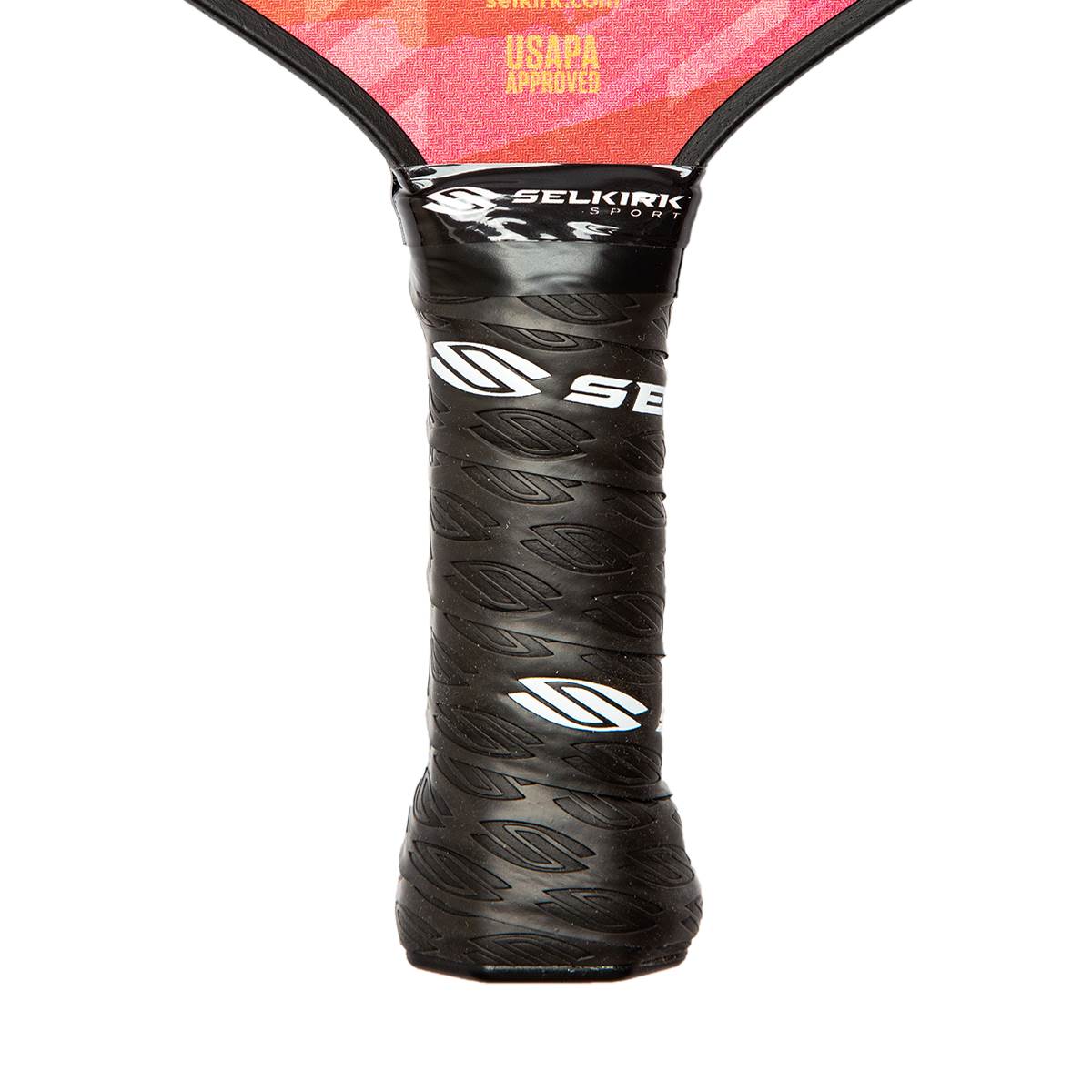 Close-up of a black pickleball paddle grip with leaf pattern and white SE logo.