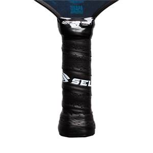 Close-up of a black pickleball paddle grip with a textured surface and the white SEL logo.