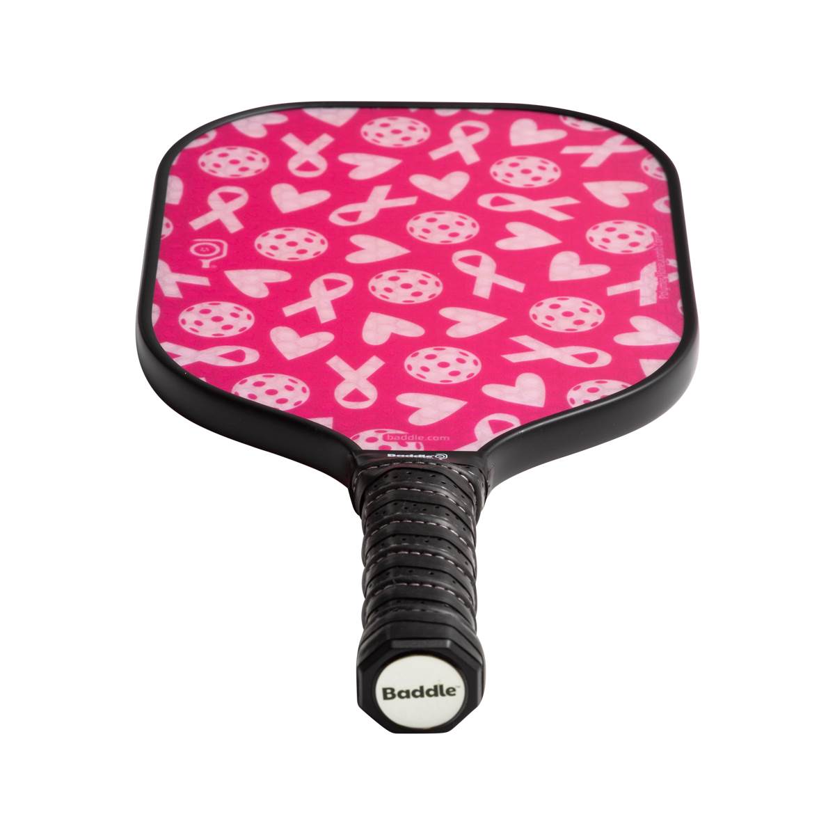 Top-down view of a pink pickleball paddle with white ribbon and heart patterns and a black grip with Baddle branding.