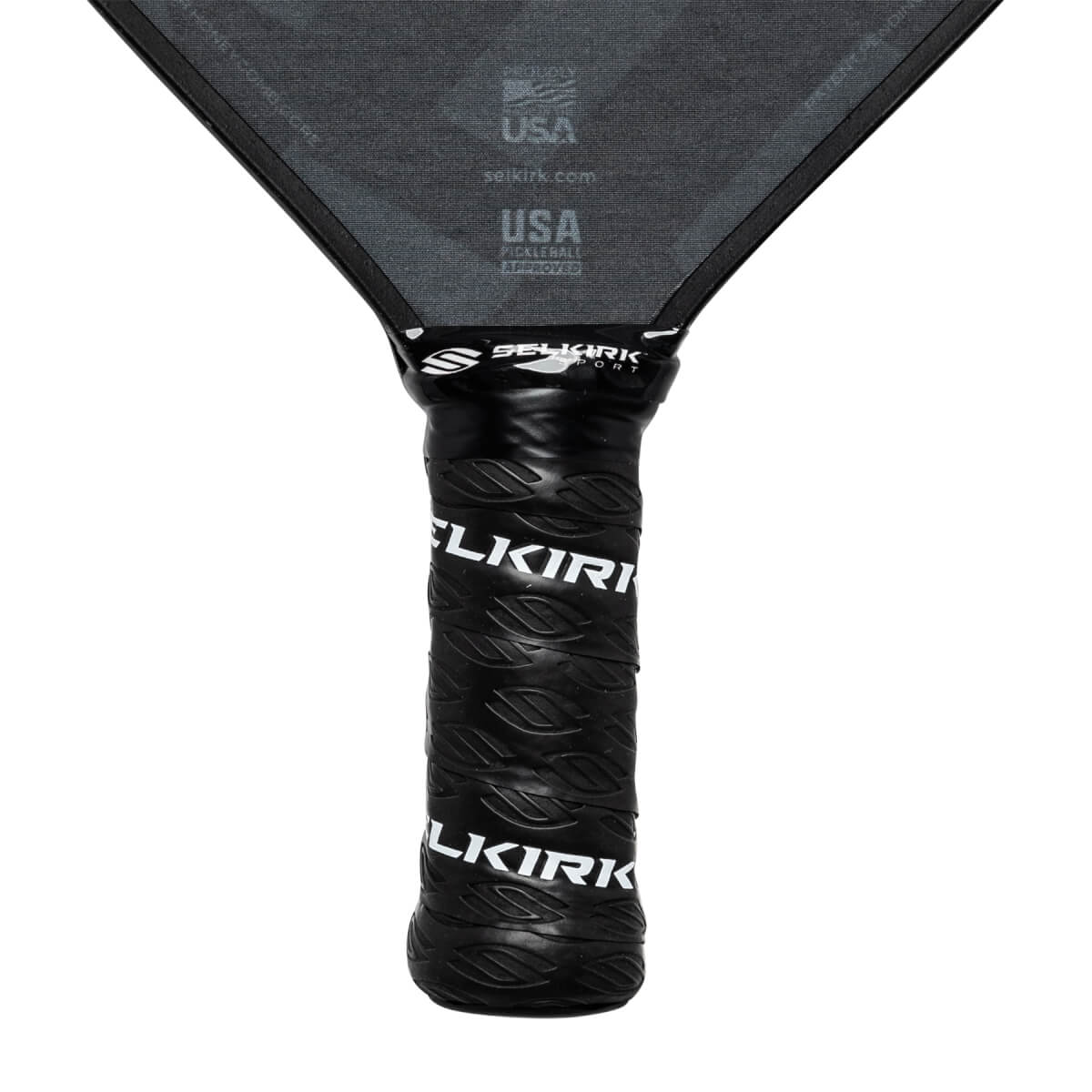 Close-up of a black pickleball paddle grip with embossed Selkirk branding and USA Pickleball Approved text on the paddle head.