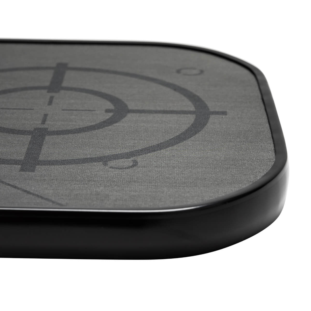 Corner view of a gray pickleball paddle with a black target design and black edge.