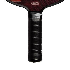 Close-up of a black pickleball paddle grip with USAPA APPROVED text on the paddle head.