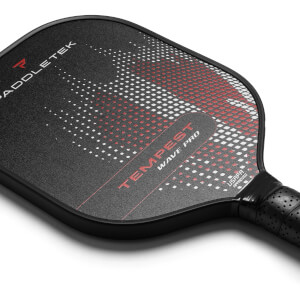 Close-up of a black pickleball paddle with red and white dot pattern, TEMPEST WAVE PRO text, and USAPA APPROVED stamp.