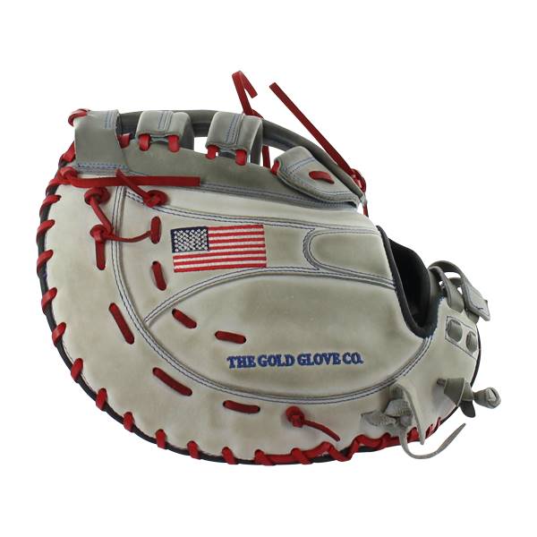 Side view of a gray first base mitt with red lacing, an American flag patch, and THE GOLD GLOVE CO. text.