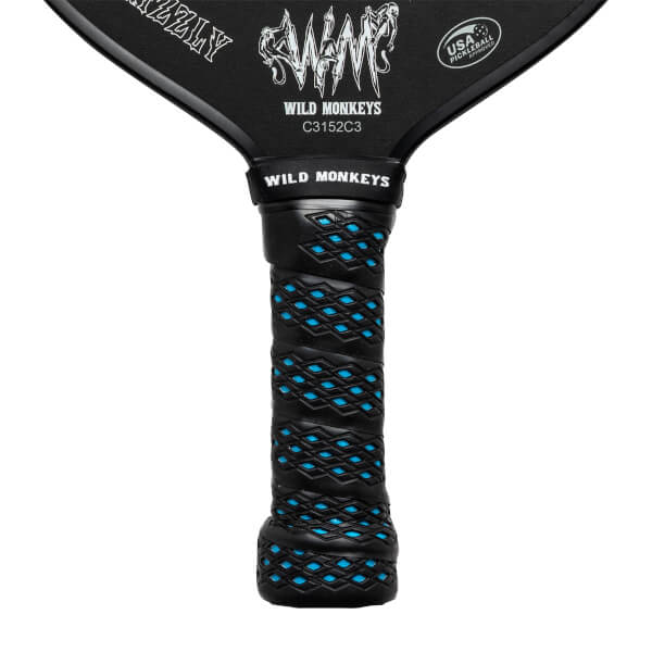Close-up of a black pickleball paddle grip with blue diamond pattern and WILD MONKEYS text.