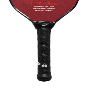 Close-up of a black pickleball paddle grip with perforations and white engage text.