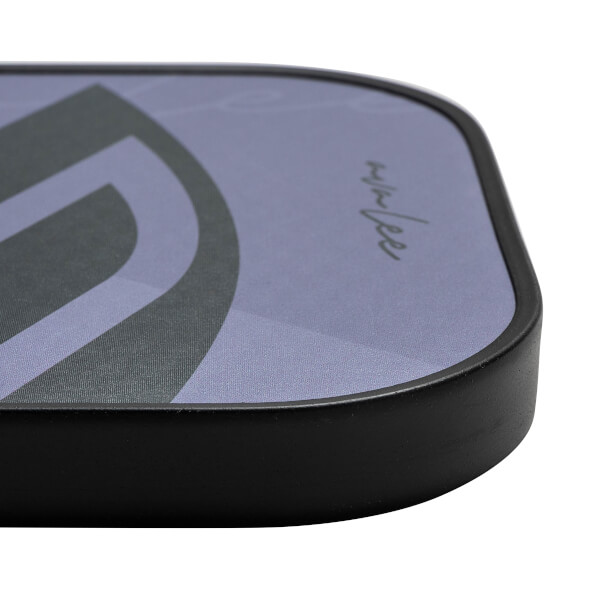 Corner view of a purple pickleball paddle with a black border and a stylized graphic.