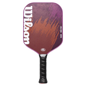 Front view of a purple and orange pickleball paddle with a large white Wilson logo and black textured grip.