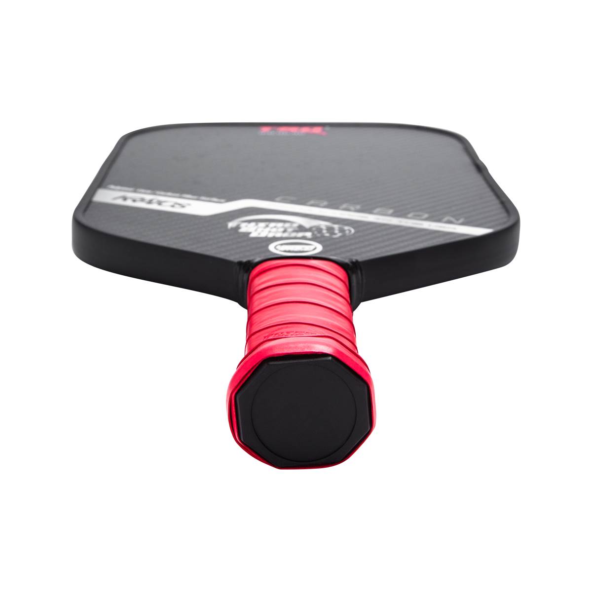 Top-down view of a black pickleball paddle with a red grip and CARBON text.