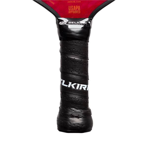 Close-up of a black pickleball paddle grip with white SELKIRK text and USAPA approved label.