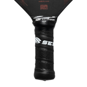 Close-up of a black pickleball paddle grip with SE logo and Selkirk Sport branding.