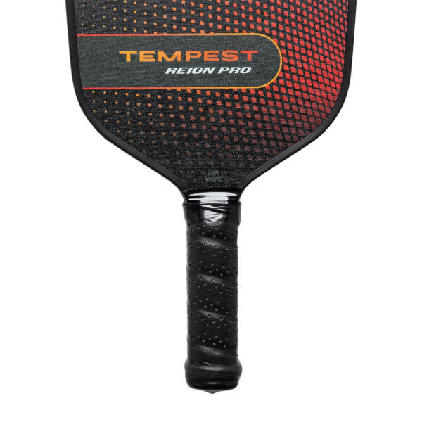Top-down view of a black pickleball paddle with TEMPEST REIGN PRO text and a gradient orange and black pattern.