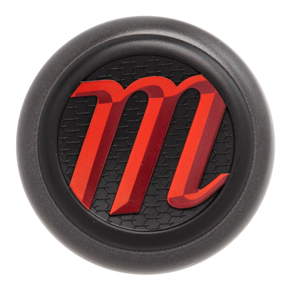 Top-down view of a black baseball bat end cap with a red m logo on a textured black background.