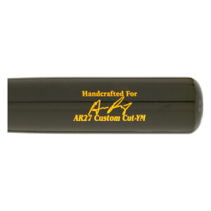 Close-up side view of a dark green baseball bat with gold Handcrafted For text, a signature graphic, and AR27 Custom Cut-YM engraving.