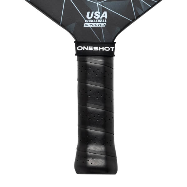 Close-up of a black pickleball paddle grip with ONESHOT branding and USA Pickleball Approved text on the paddle head.