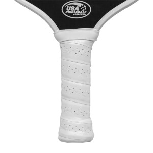 Close-up of a white pickleball paddle grip with perforations and a USA Pickleball Approved logo.