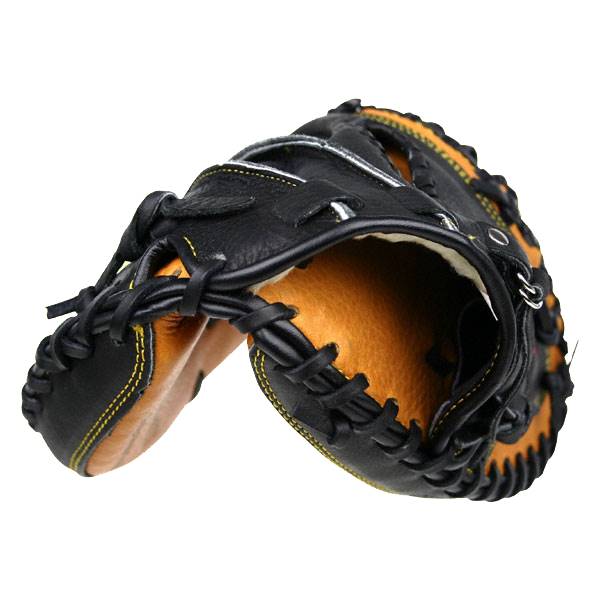 Top-down view of a black catchers mitt with tan interior and yellow stitching.