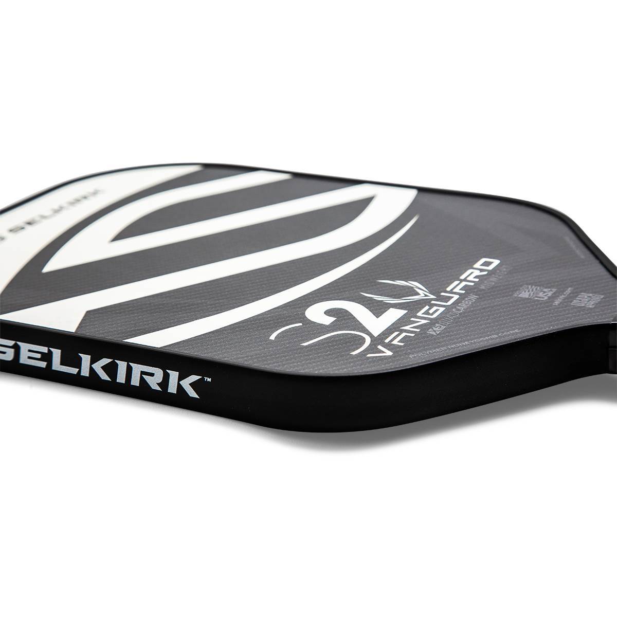Side view of a black pickleball paddle with white Selkirk branding and S2 Vanguard text.