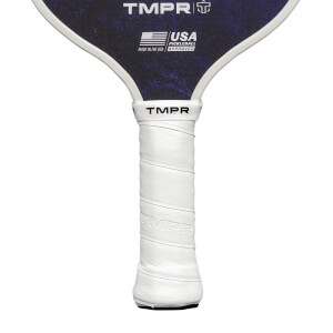 Close-up of a white grip on a pickleball paddle with TMPR branding and USA Pickleball Approved logo.