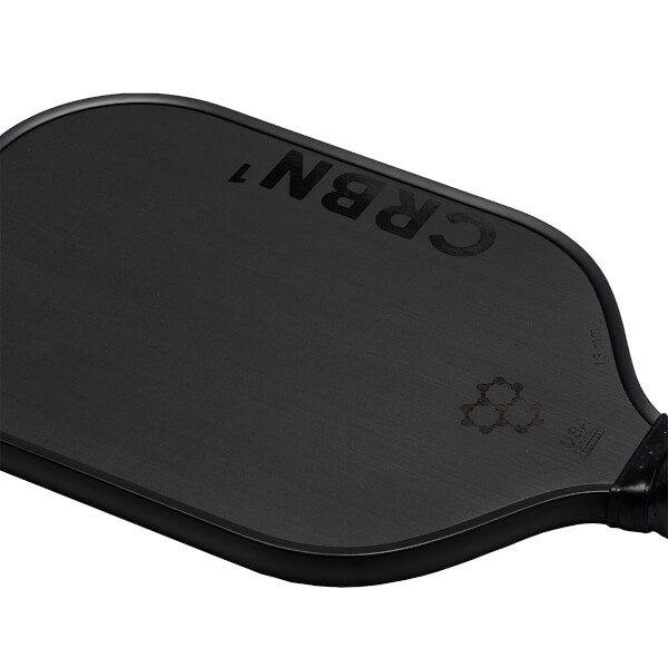 Close-up of a black CRBN pickleball paddle with CRBN 7 and a honeycomb logo.