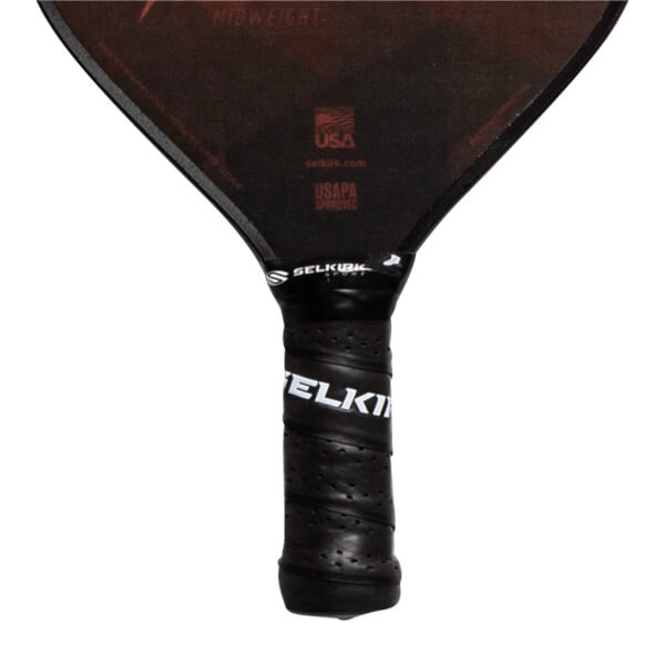 Top-down view of a black pickleball paddle with SELKIRK branding on the grip and MIDWEIGHT text.