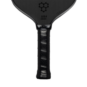 Top-down view of a black pickleball paddle with a honeycomb logo and USA PICKLEBALL APPROVED text.