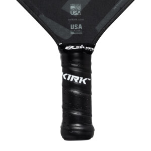 Close-up of a black pickleball paddle grip with KIRK branding and SELKIRK logo.
