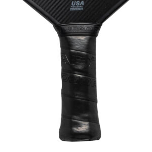 Close-up of a black pickleball paddle grip with HEAD and PERFORMANCE text.