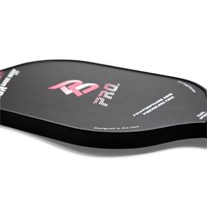 Corner view of a black pickleball paddle with pink PB PRO logo and Designed in the USA text.