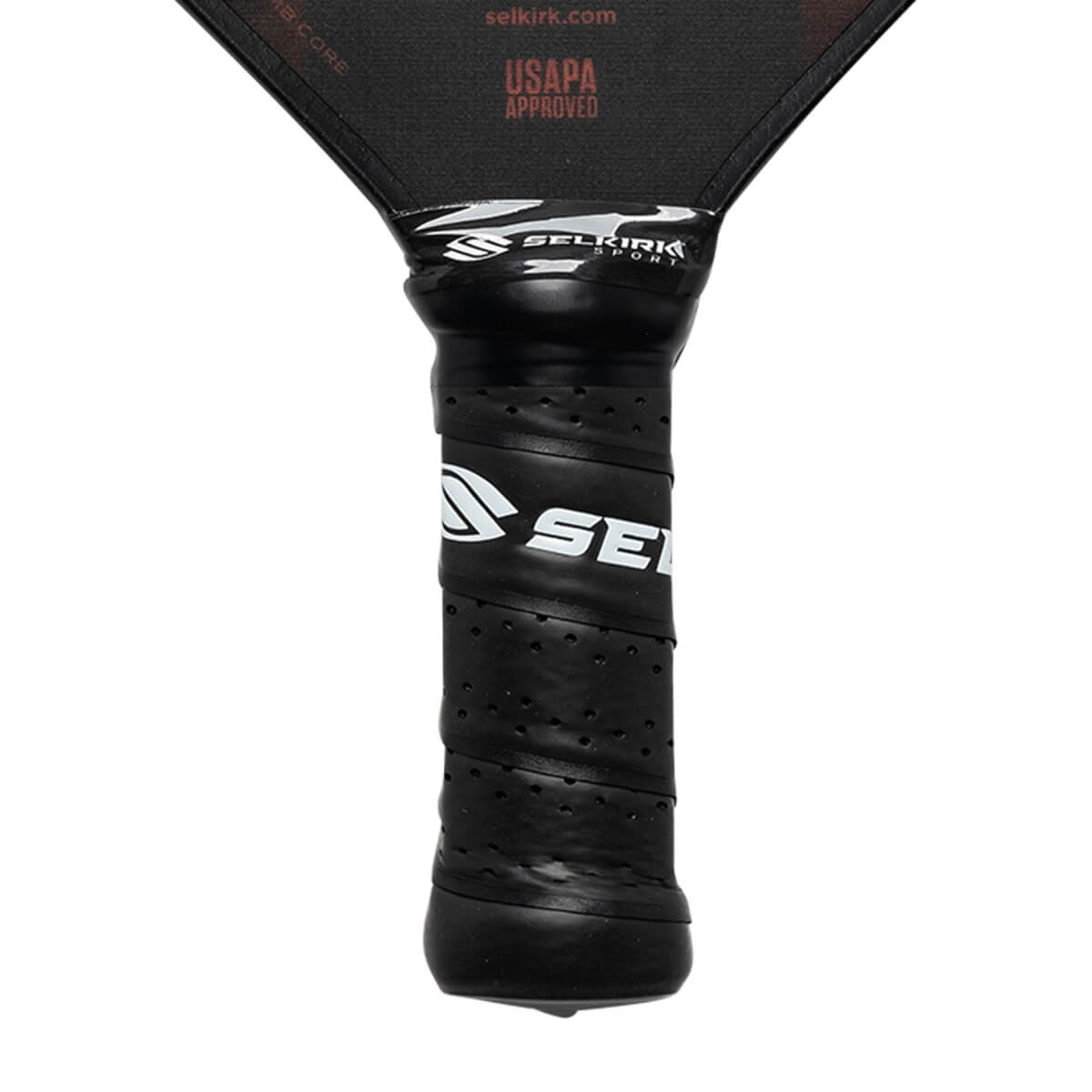 Close-up of a black pickleball paddle grip with SE logo and Selkirk Sport branding.