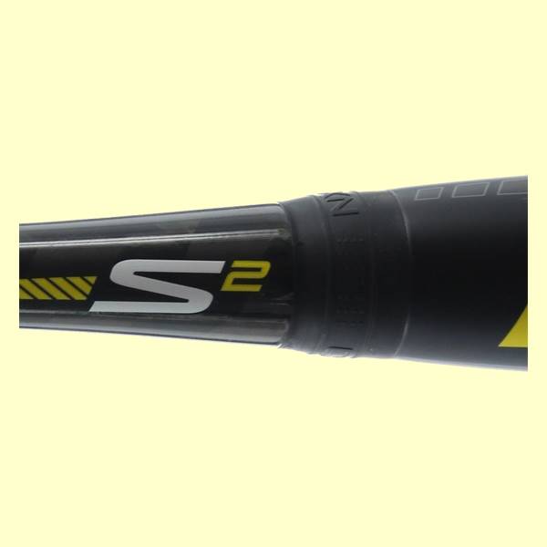 Close-up of a black baseball bat with white S2 logo and yellow accents.