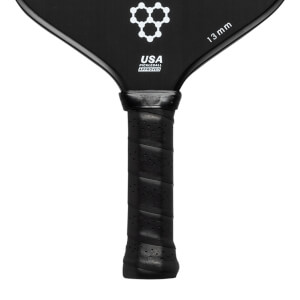 Close-up of a black pickleball paddle with a perforated grip, USA PICKLEBALL APPROVED text, and 13 mm marking.