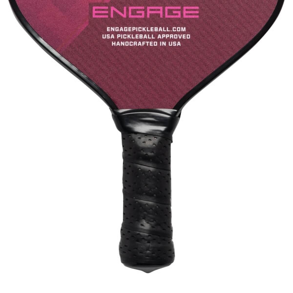 Close-up of a black pickleball paddle grip with perforated texture and Engage branding on the head.