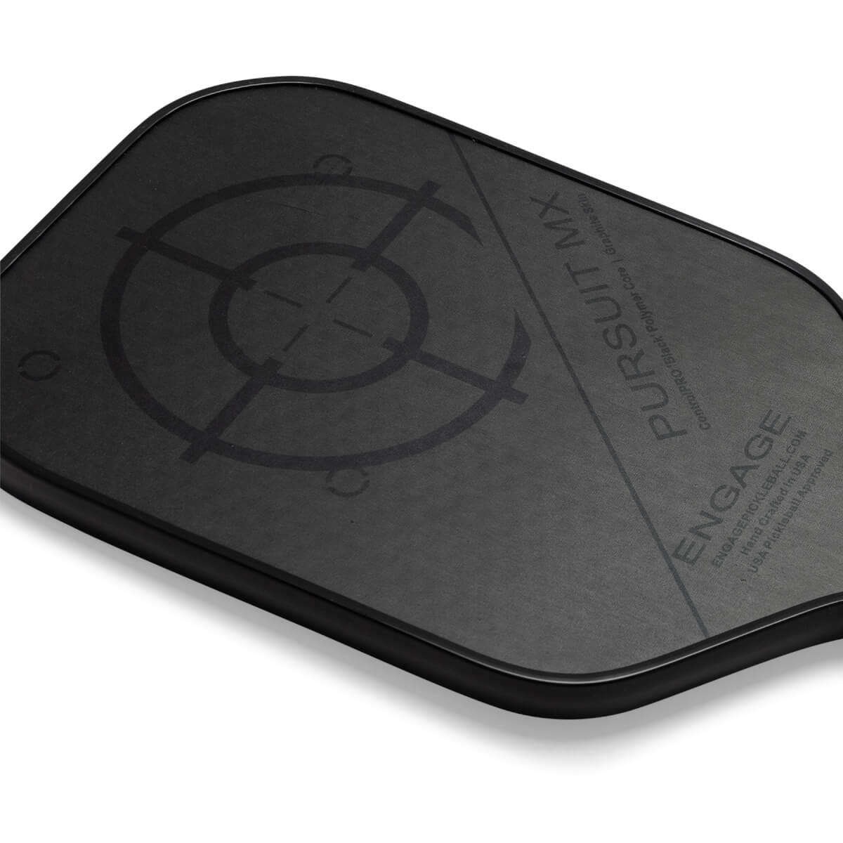 Corner view of a black pickleball paddle with a target design and PURSUIT MX text.