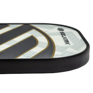 Side view of a white pickleball paddle with black and gold accents and Selkirk branding.