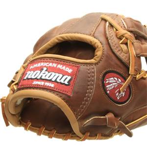 Close-up of a brown leather baseball glove with a red nokona AMERICAN MADE SINCE 1934 patch and a circular logo.