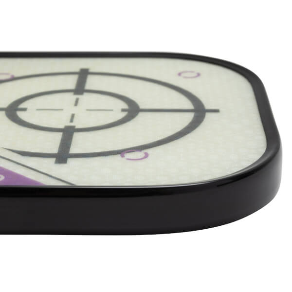 Corner view of a white pickleball paddle with a black edge and target design.