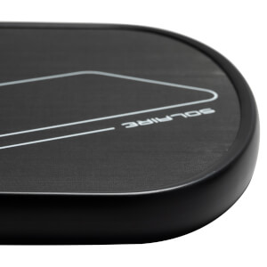 Corner view of a black pickleball paddle with white SOLAIRE text and a geometric design.