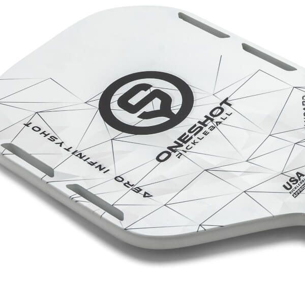 Corner view of a white pickleball paddle with a black logo, geometric pattern, and text.