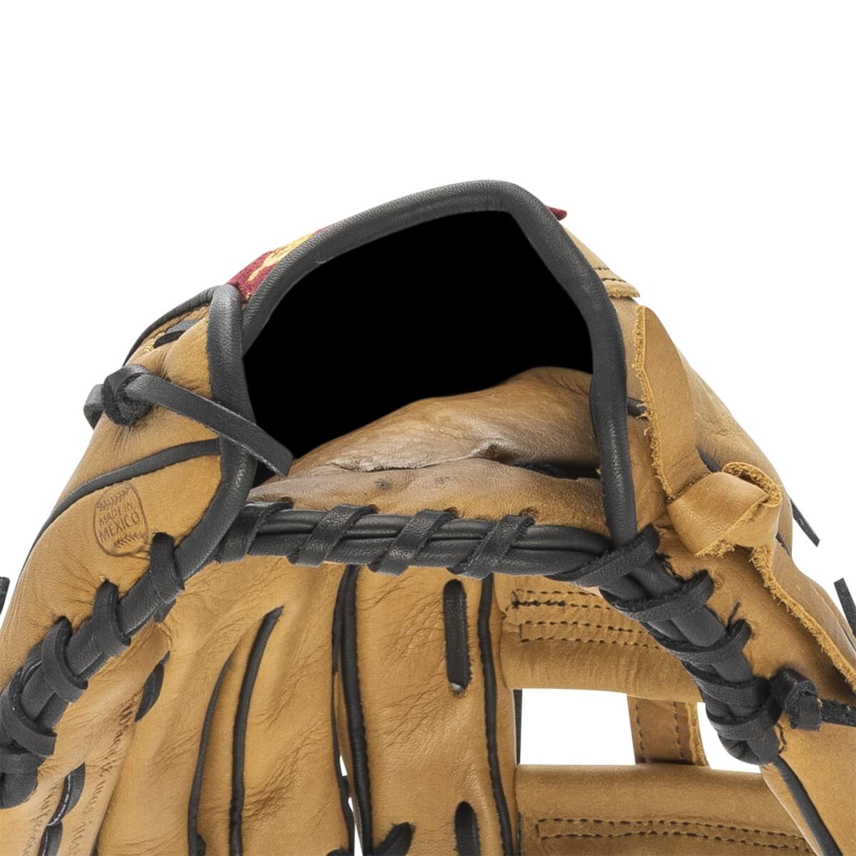 Close-up of tan baseball glove with black lacing, a dark interior, and MADE IN MEXICO stamp.