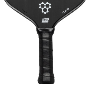 Top-down view of a black pickleball paddle with a white honeycomb logo, USA PICKLEBALL APPROVED text, and 13 mm marking.