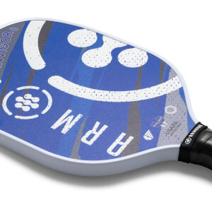 Close-up of a blue pickleball paddle with white speckles, the word ARM and USAPA approved logo.
