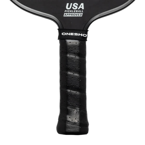Close-up of a black pickleball paddle grip with ONESHO branding and USA PICKLEBALL APPROVED text.